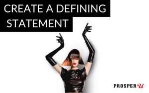 Model in black latex and modern styled wig pointing to "Create a Defining Statement"